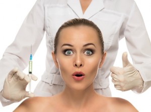 Beautiful woman face,beautician hands with syringe